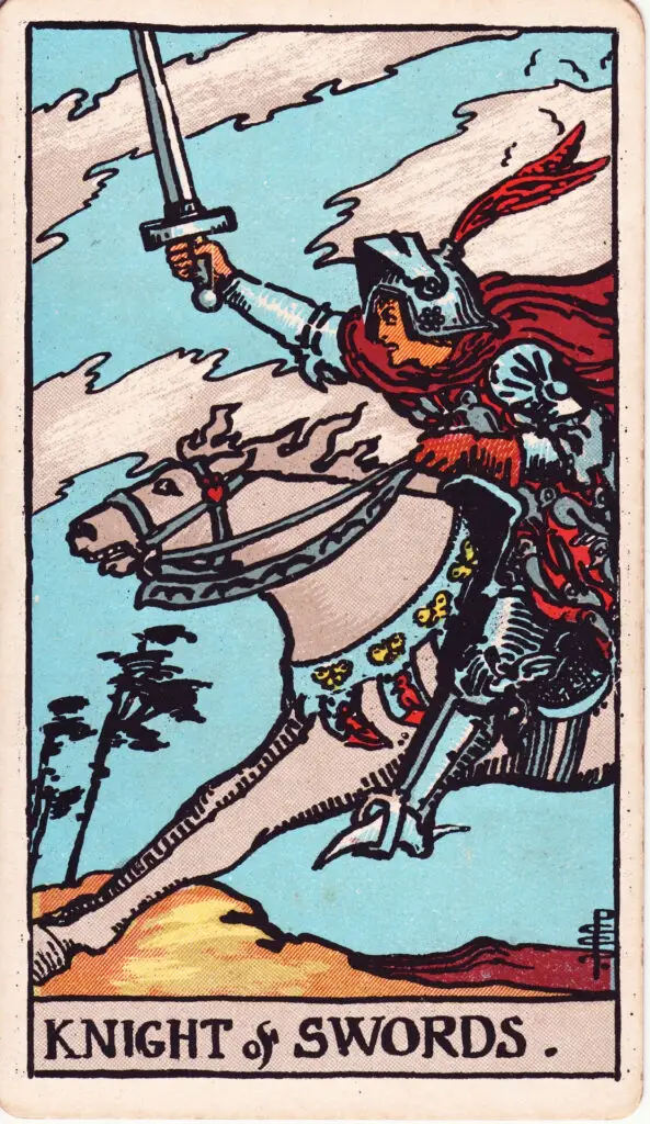 Illustration du Cavalier d’Épées du tarot Rider Waite : un chevalier charge à toute allure sur un cheval blanc, brandissant son épée, dans un paysage balayé par le vent et les nuages.